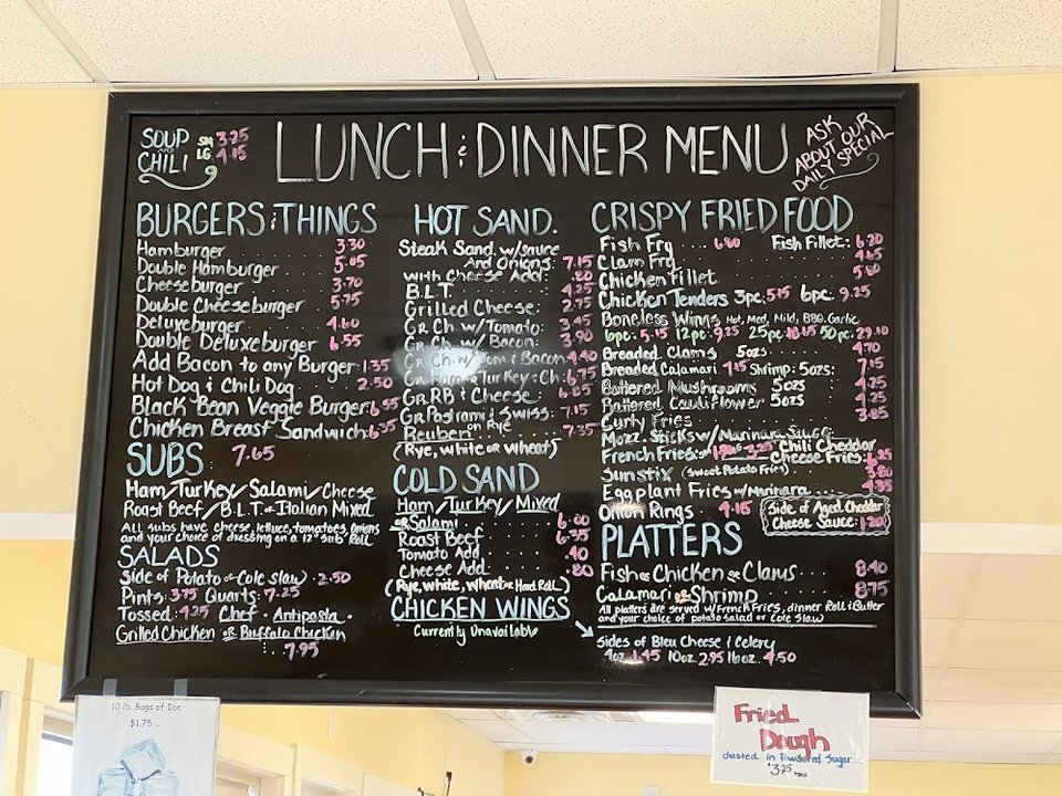Printed menu featuring grill items and sandwiches.